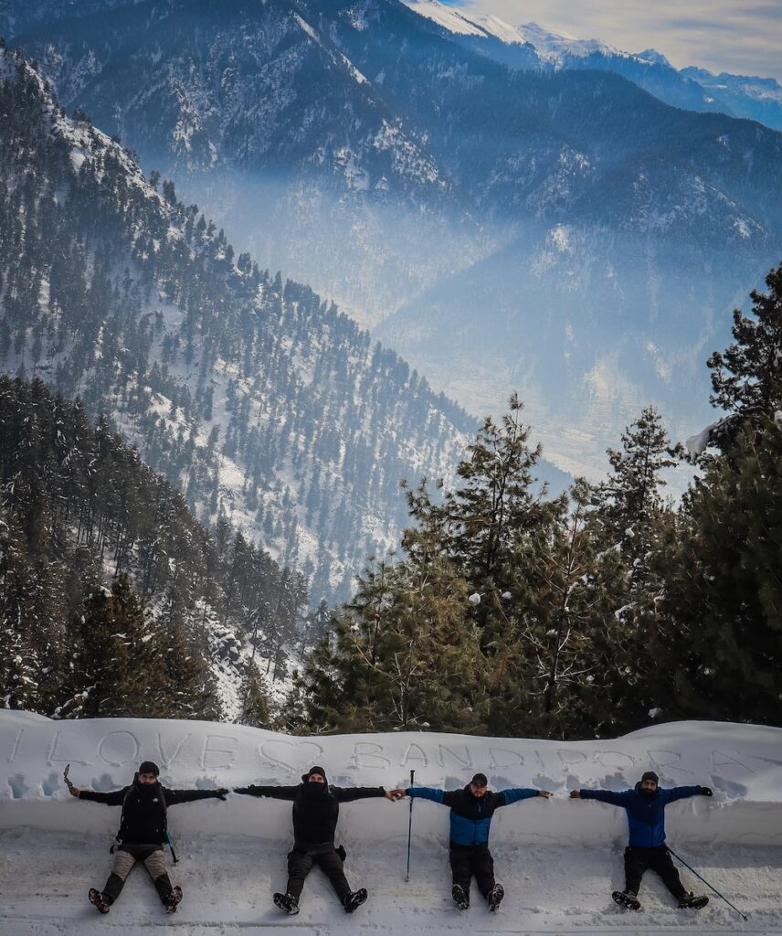 a group of people riding skis on top of a snow covered slope